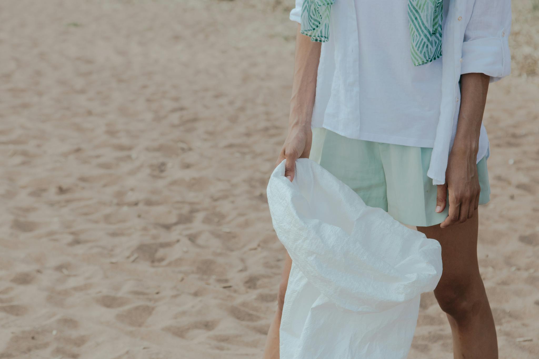 Volunteer holding a sack for eco-friendly beach clean-up activity.